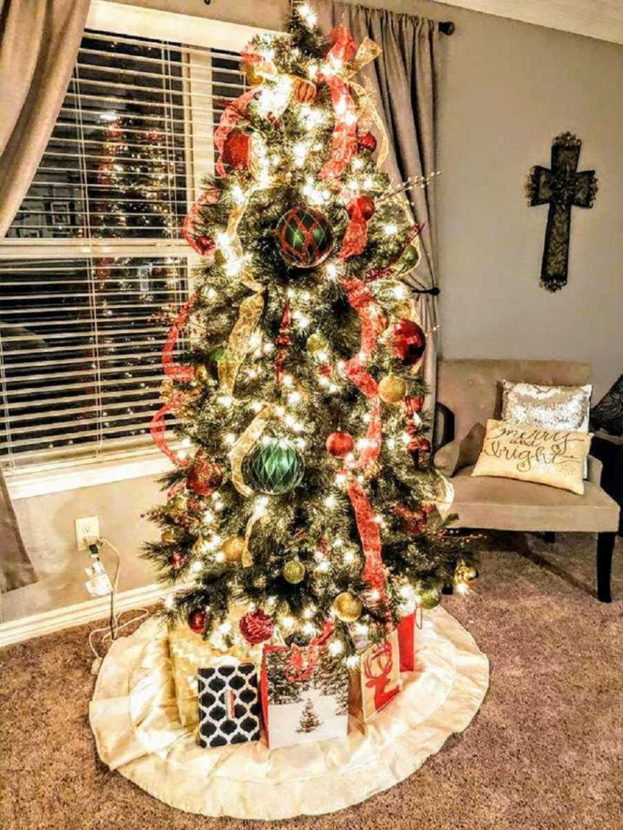 Decorated Christmas tree with three presents under it 