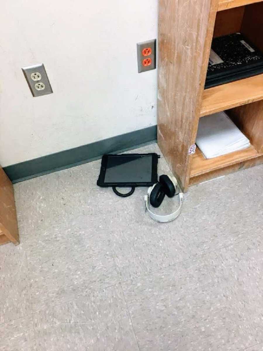 iPad and headphones lying on classroom floor