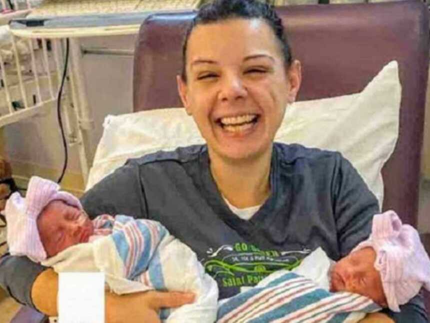 mom holding twin girls in hospital