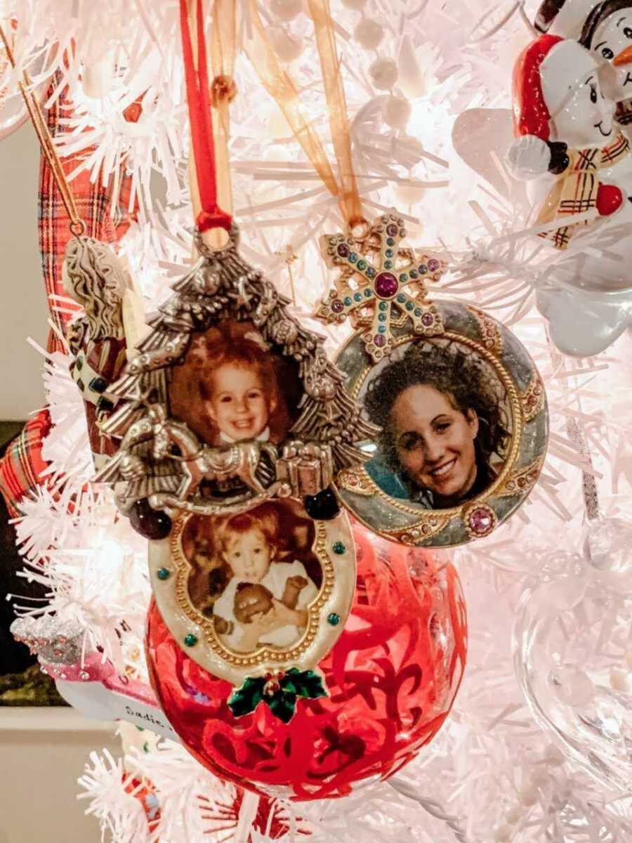 Ornaments with photos hung on white Christmas tree 