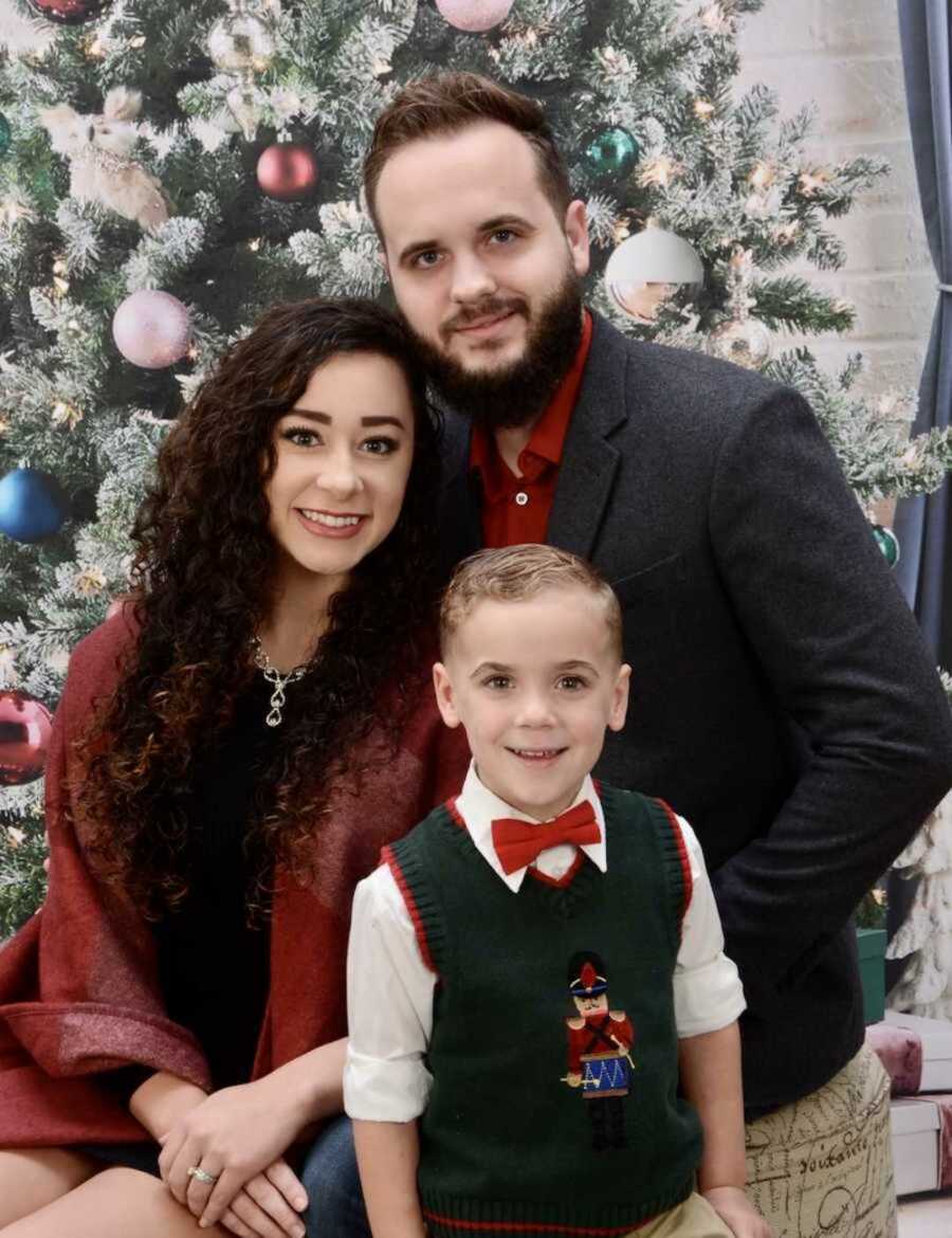 bonus mom sits with husband and child in festive Christmas outfits