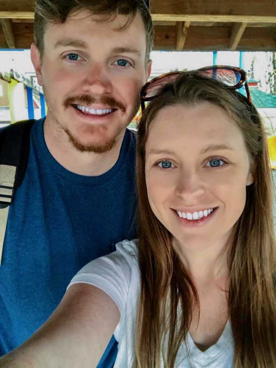 wife takes a selfie with her husband, both are smiling