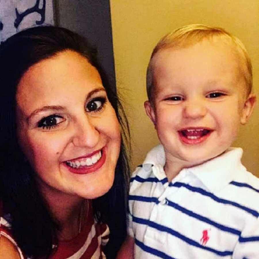 Mom smiling next to toddler in striped polo shirt