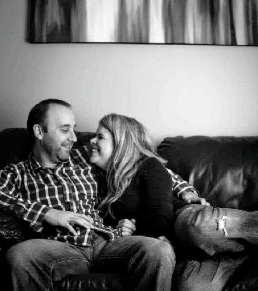 couple laughing together on couch
