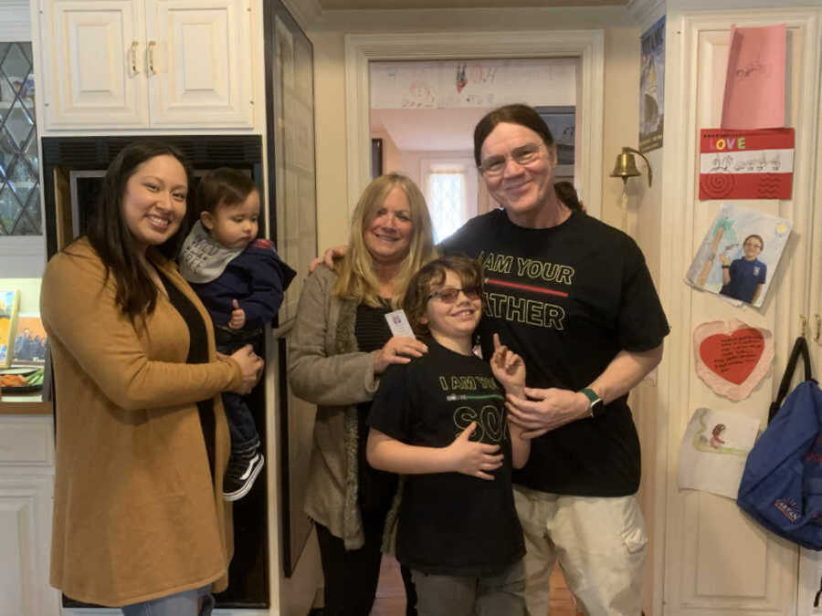 Family smiling in kitchen