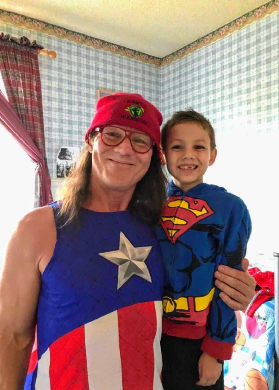 Foster dad and son wearing superhero costumes