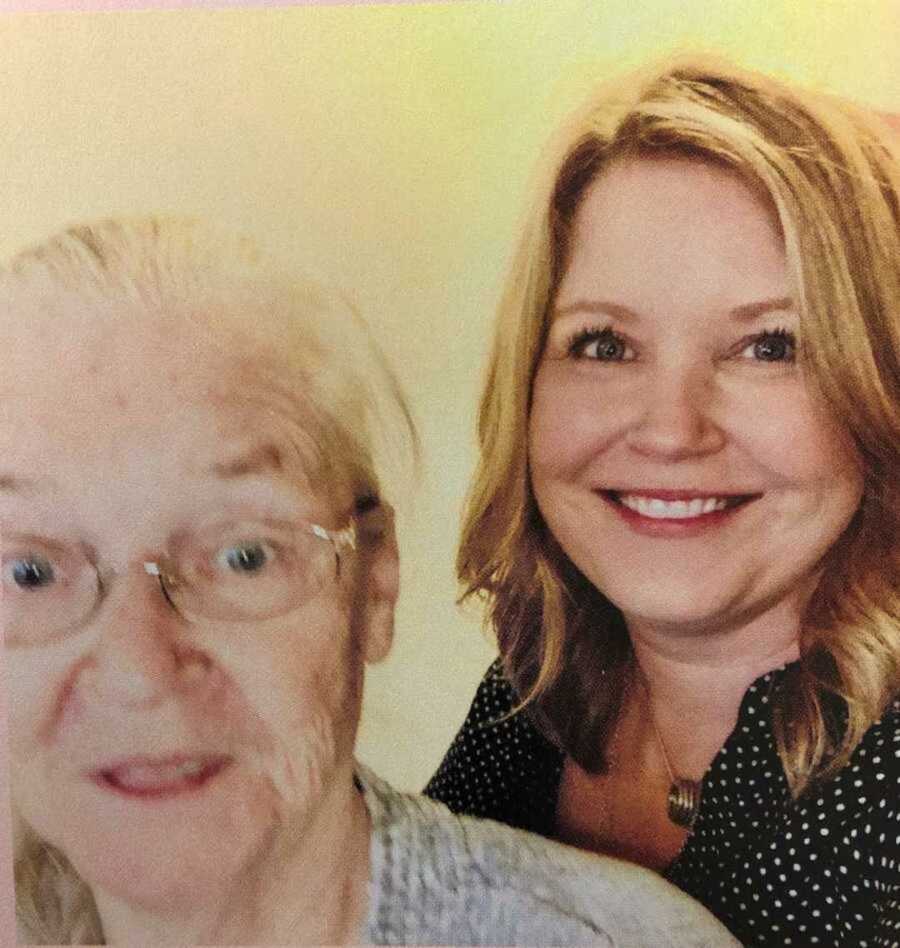 daughter smiles with mom with Alzheimer's
