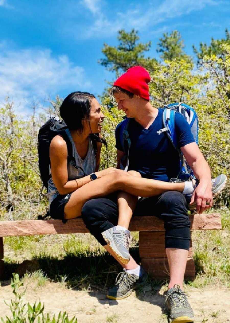 man and wife laughing while outside