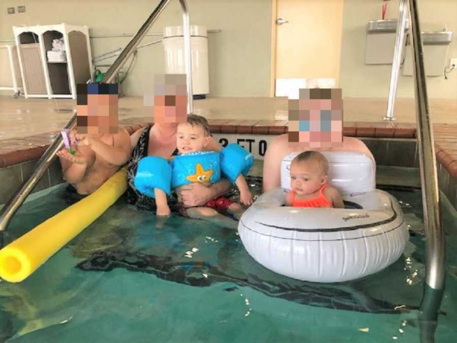 Foster children smiling in pool