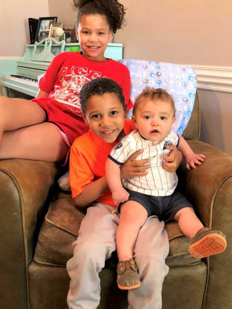 Adoptive siblings sitting on brown leather seat