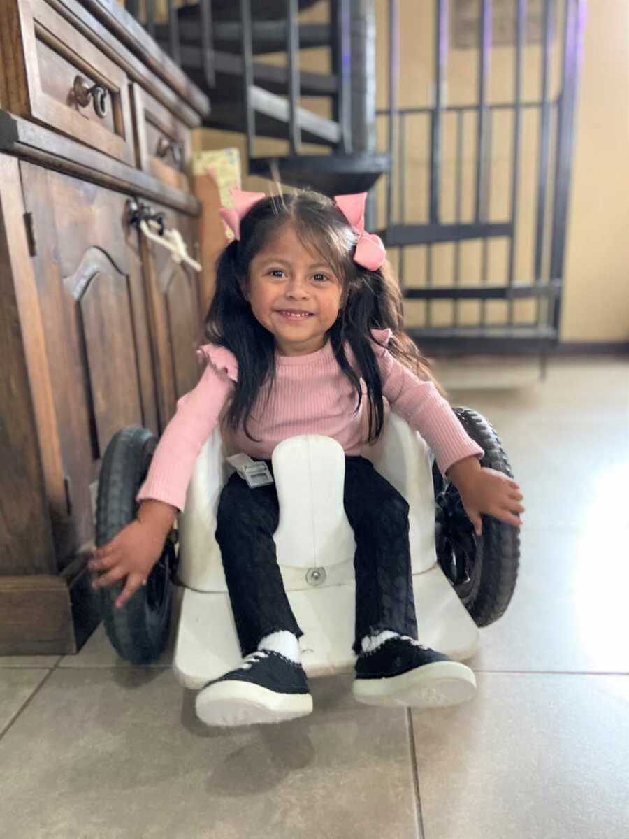 Special needs girl with pink ribbons in her hair