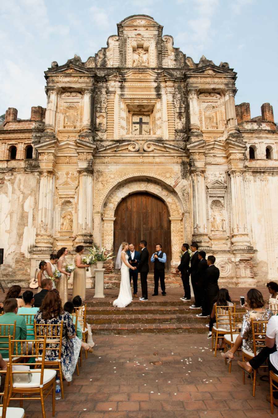 Bride and groom standing at altar of Guatemalan church