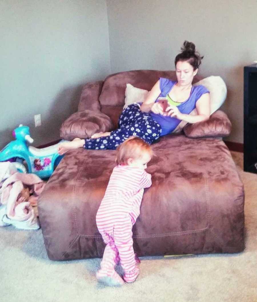 mom on her phone while ignoring toddler