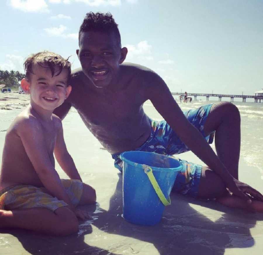 Smiling Adopted And Biological Brother At The Beach Playing In Sand