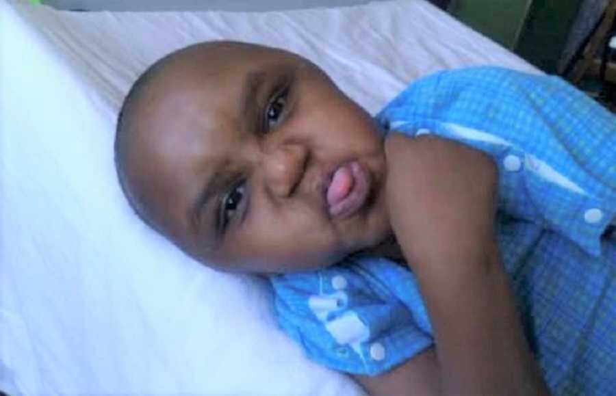 Adopted Ethiopian Boy In Blue Sticking Out Tongue