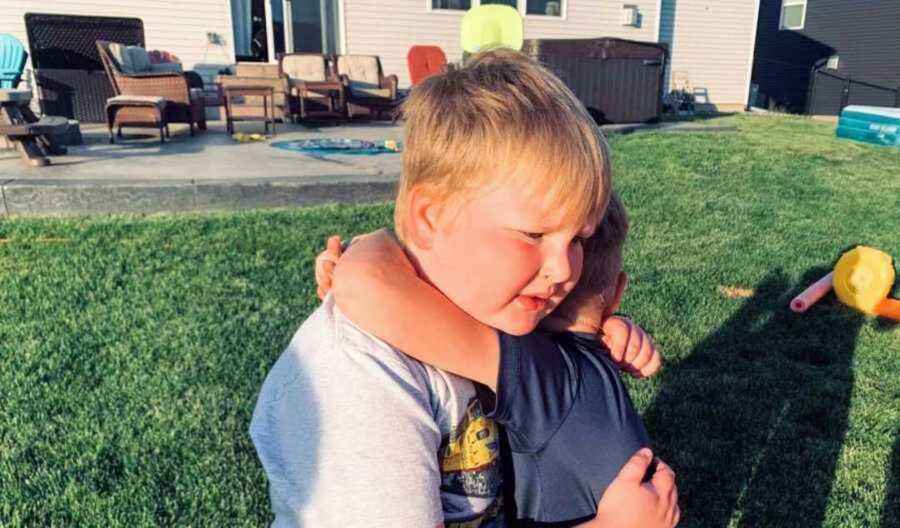 boy hugging brother with autism