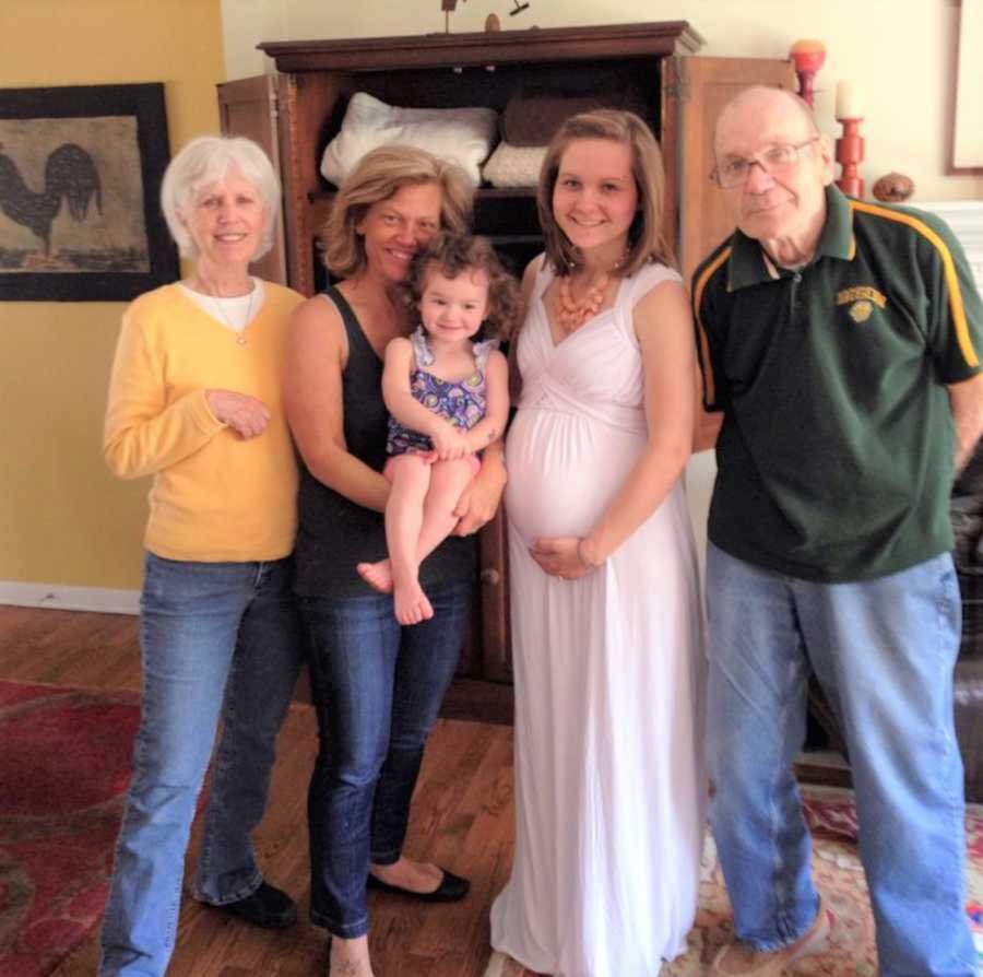 Family of five smiling in living room