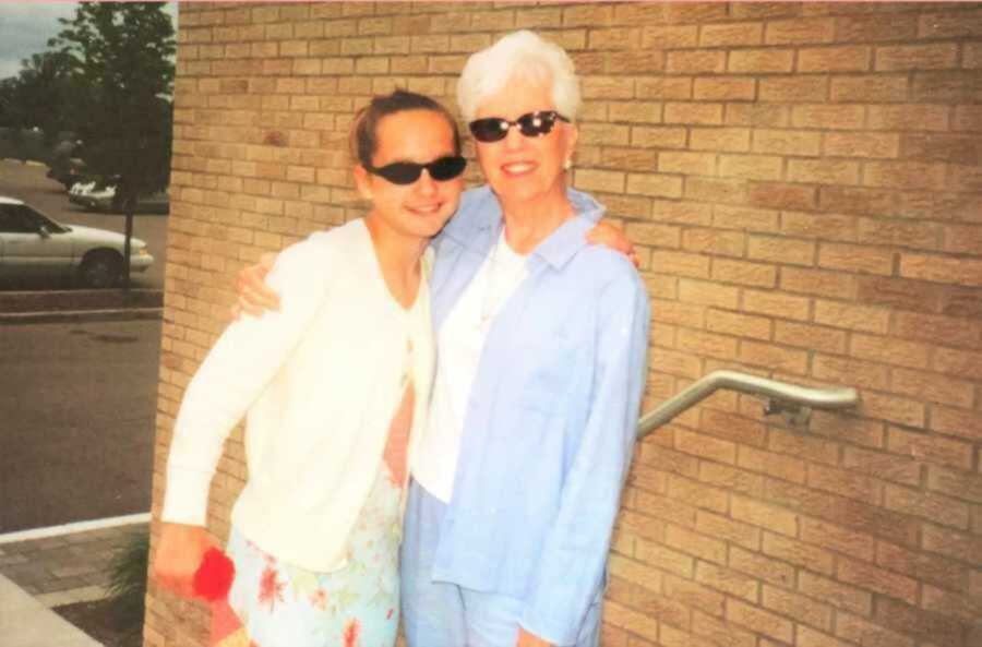 Grandma and granddaughter posing in black sunglasses