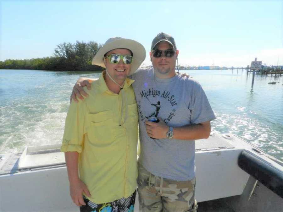 two men smiling on boat