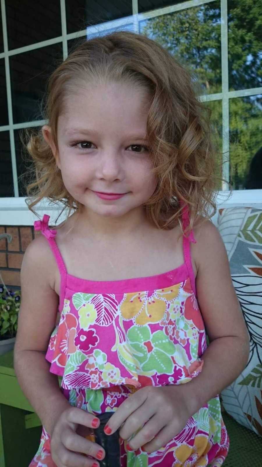 Little girl wearing floral pink dress