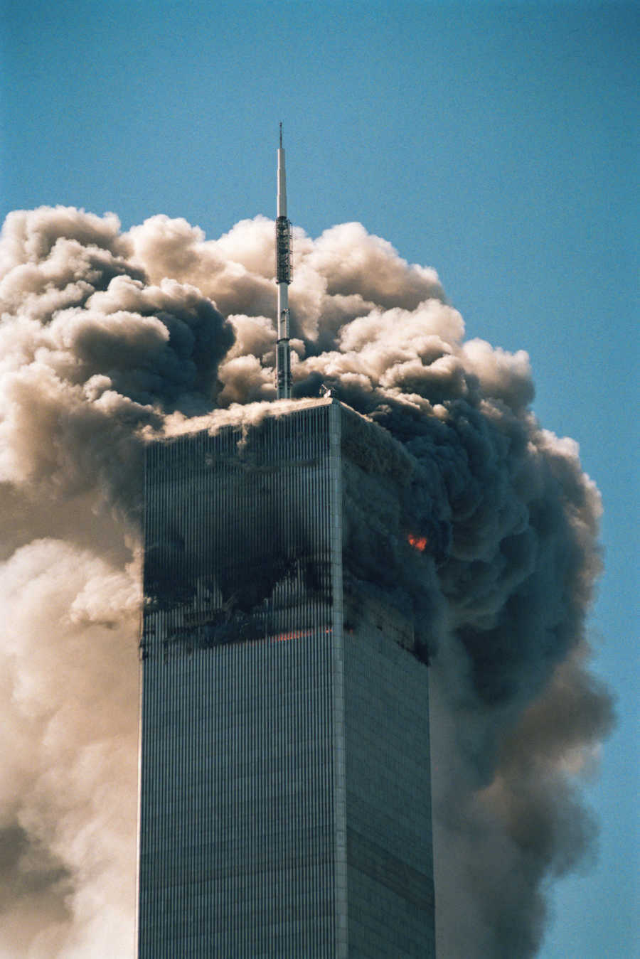 One of the twin towers as a plane crashes into it and bursts into flames