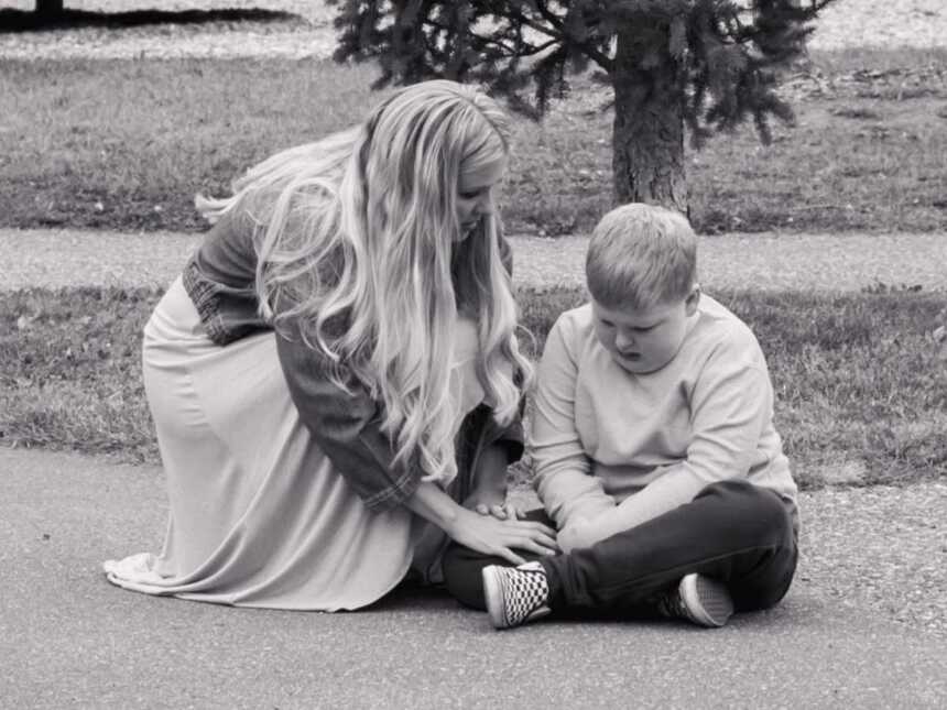 black and white photo of mom sitting with son