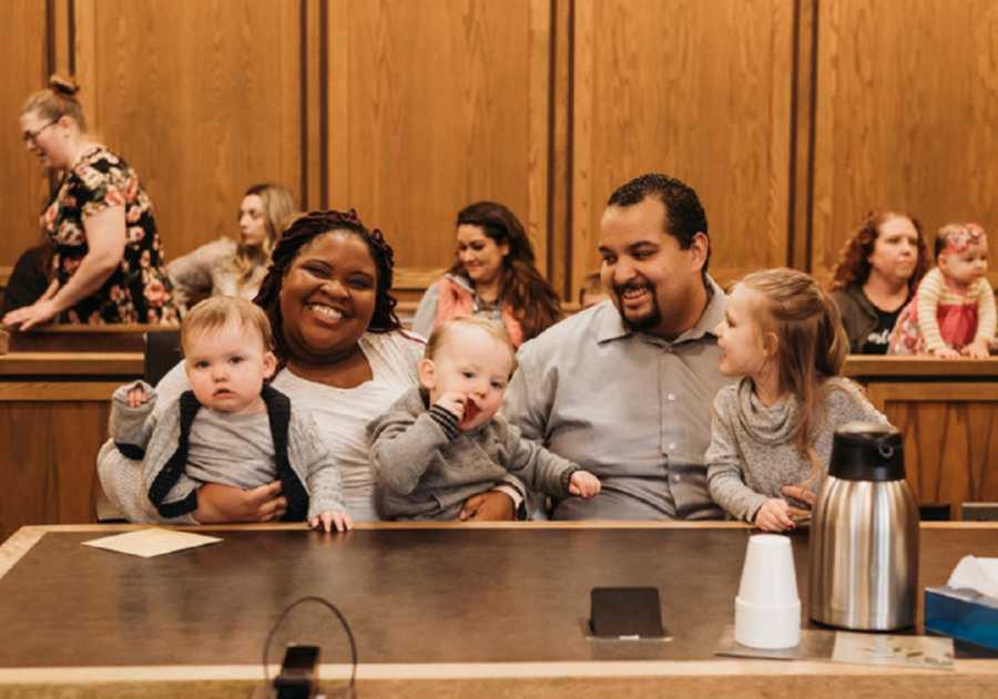 Adoptive family sitting in courtroom