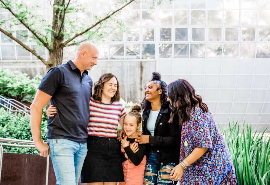 Adoptive family smiling and laughing together