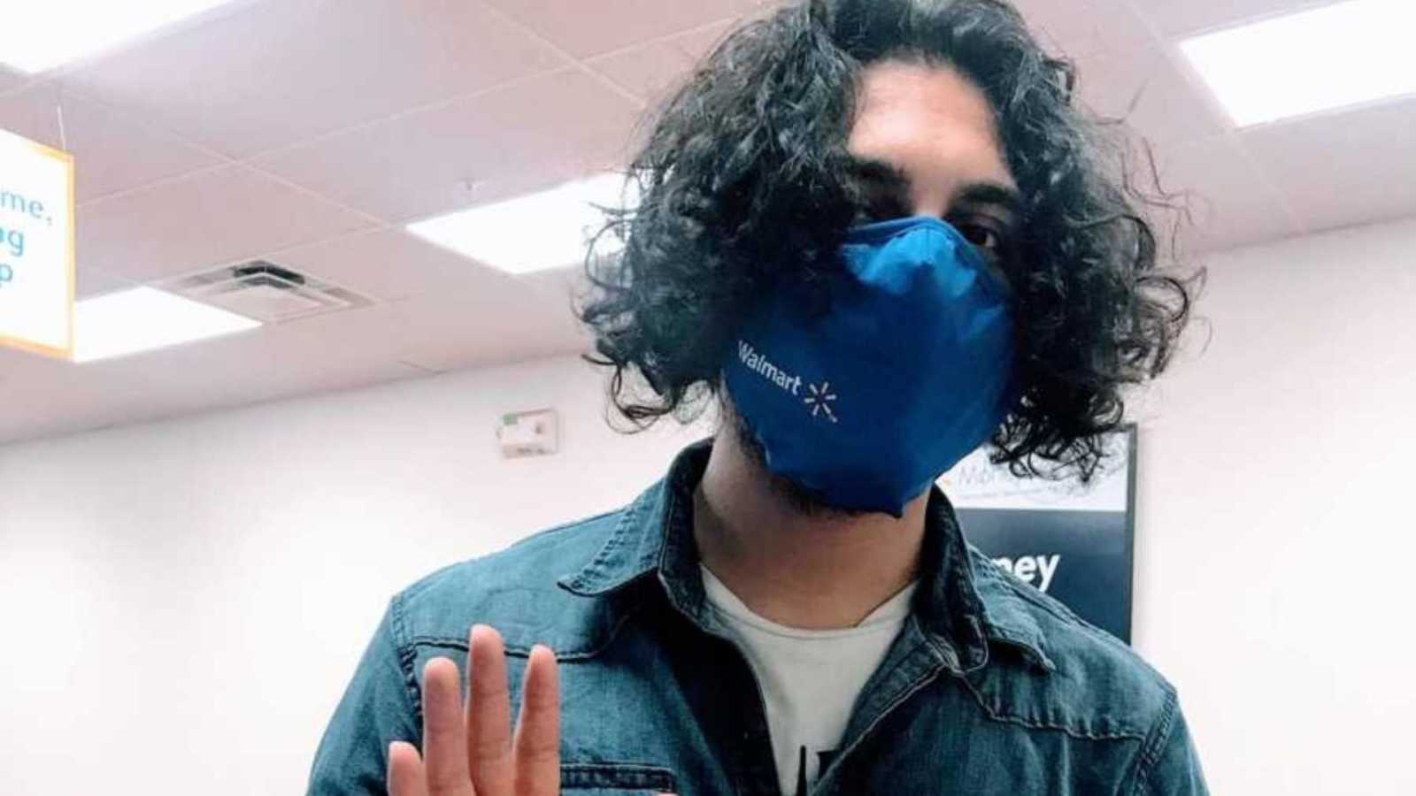 Walmart employee wearing mask while waving