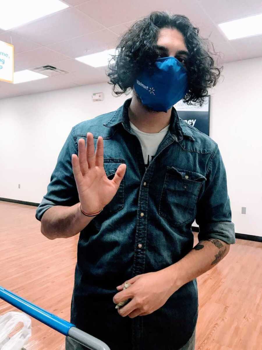 Masked Walmart employee waving