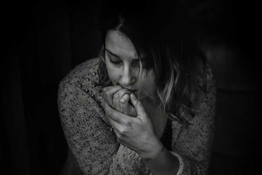 anxious woman biting nails