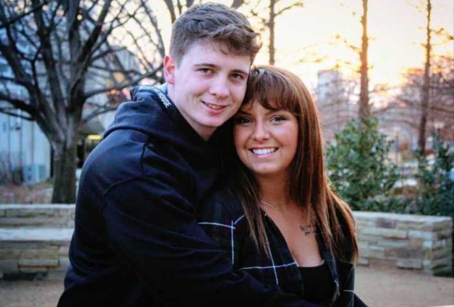 Young wife and husband smiling in driveway