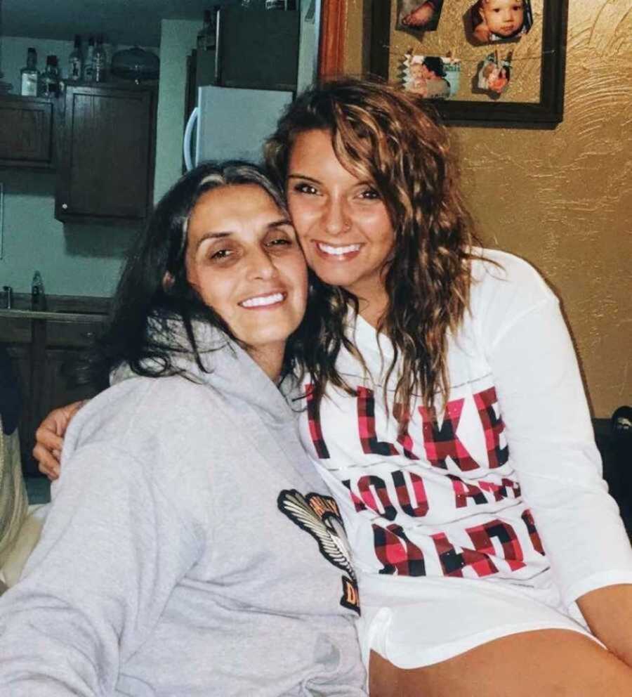 Daughter and mom smiling together on couch