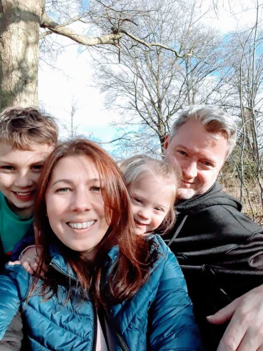 Selfie of special needs family in forest 