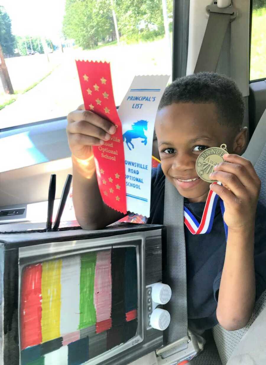 Dwayne shows some of his school awards and recognition. 