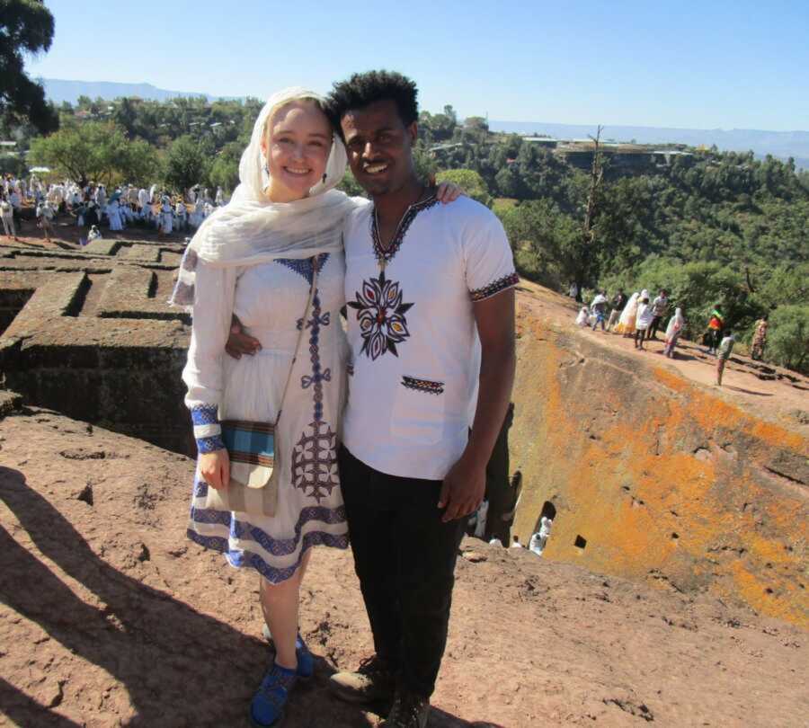 Biracial couple embraces each other for photo