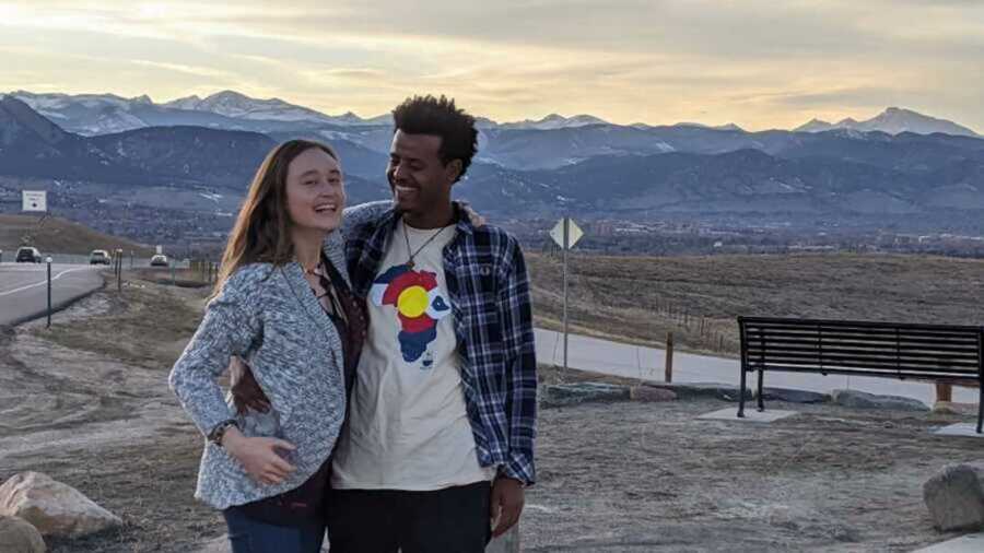 Candid photo of couple as they smile during sunset