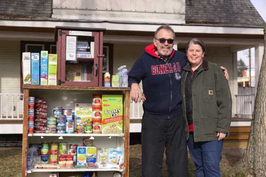 couple smiling by outdoor food pantry
