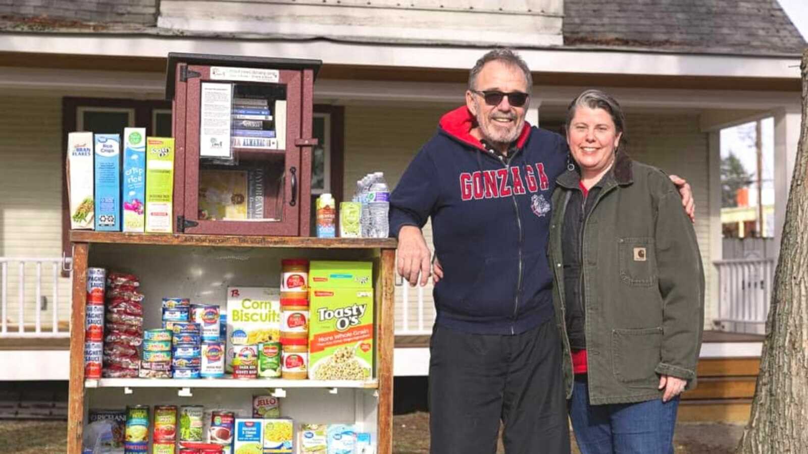 couple smiling by food pantry
