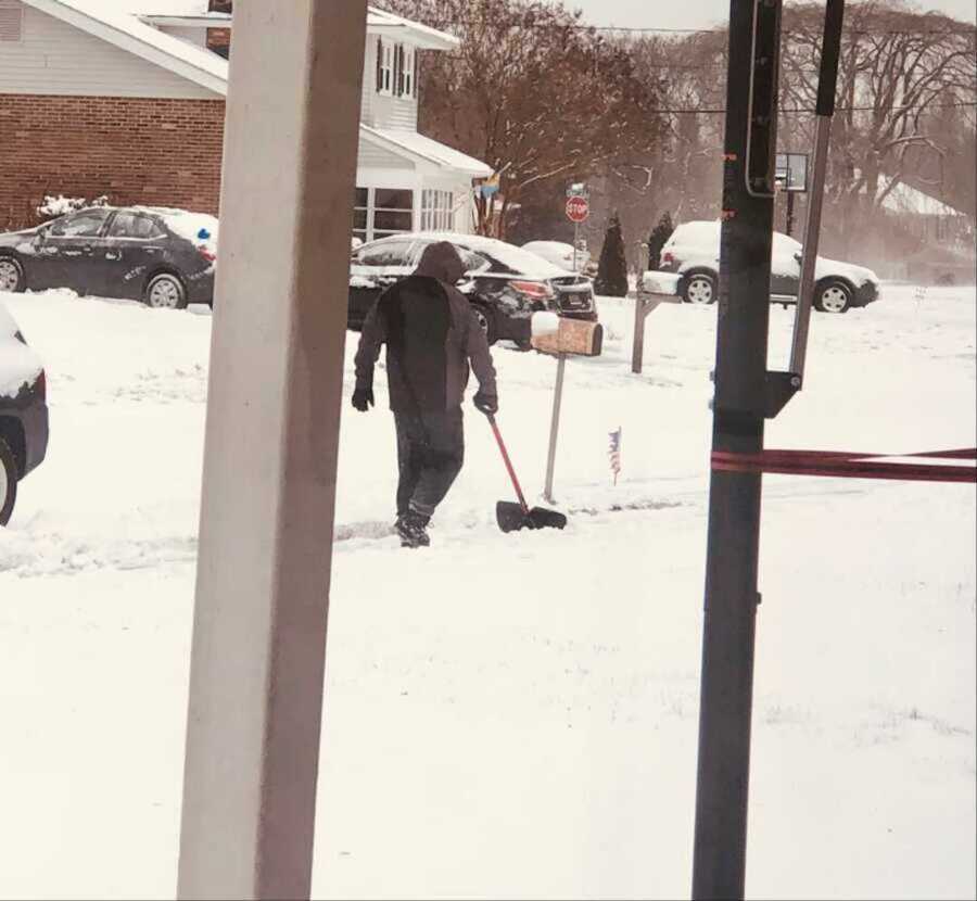 man outside shoveling snow
