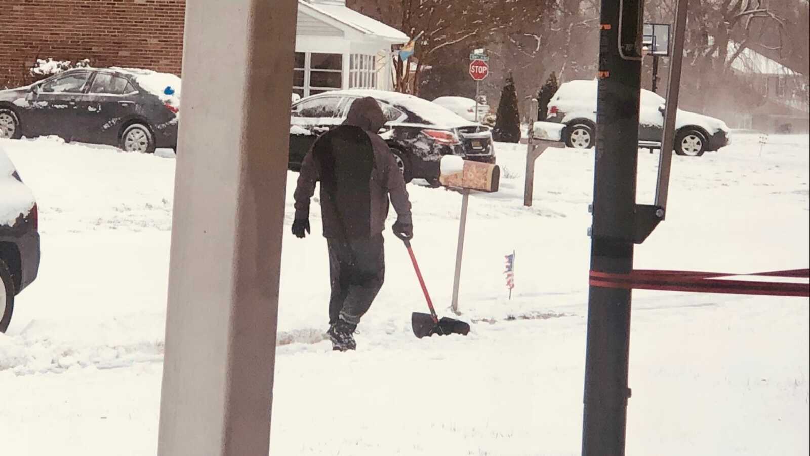 man shoveling snow outside