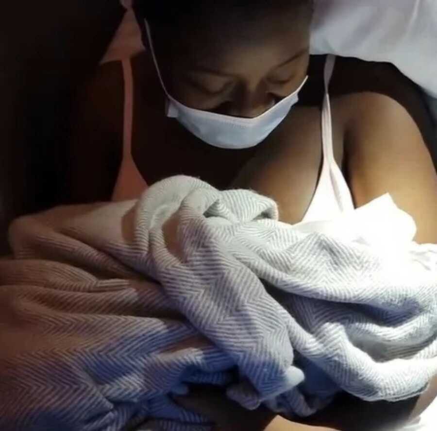 woman who gave birth on an 11 hour flight holding her baby