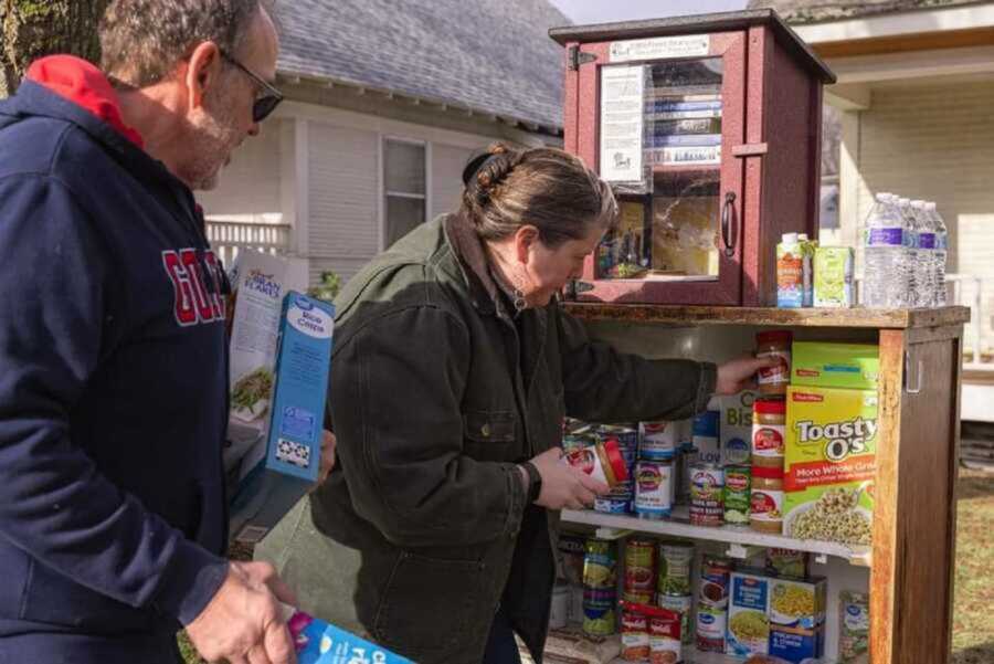 couple grabbing food in outdoor food pantry