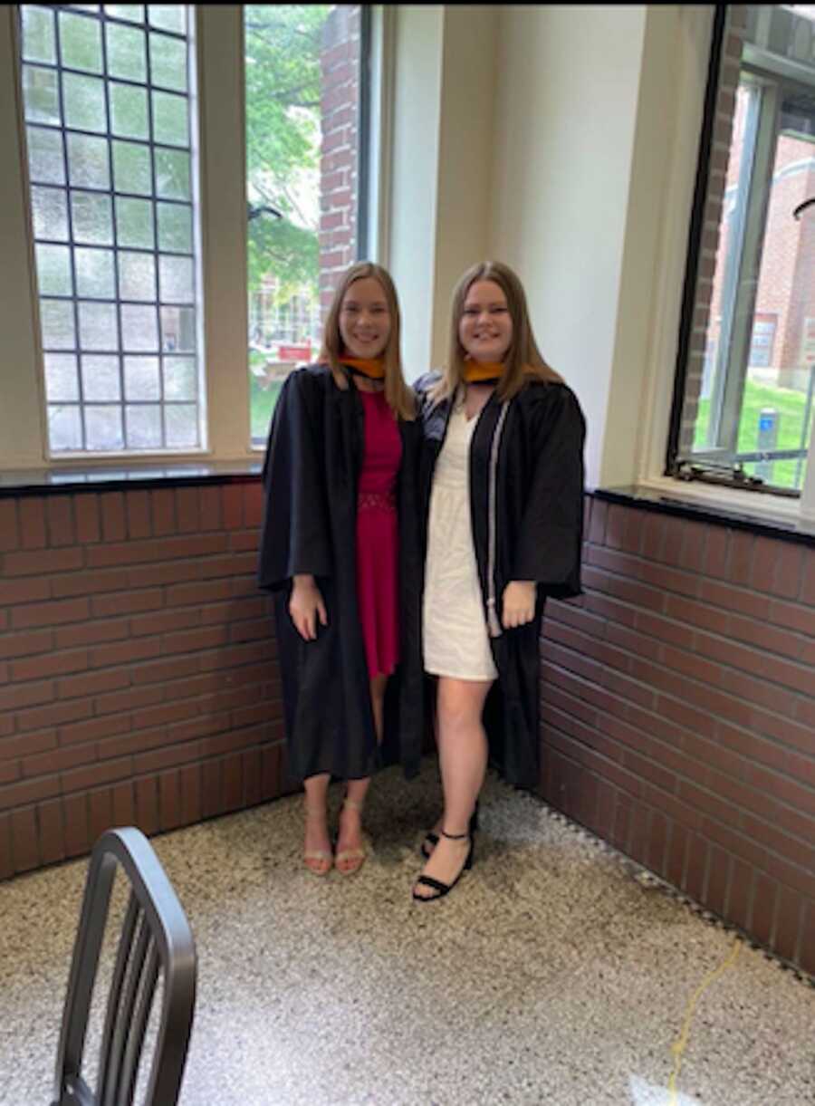 two girls wearing their cap and gown for their college graduation