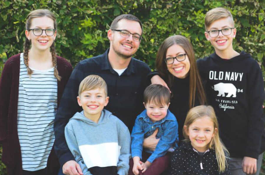 family photo of 7 including adopted son with Down syndrome