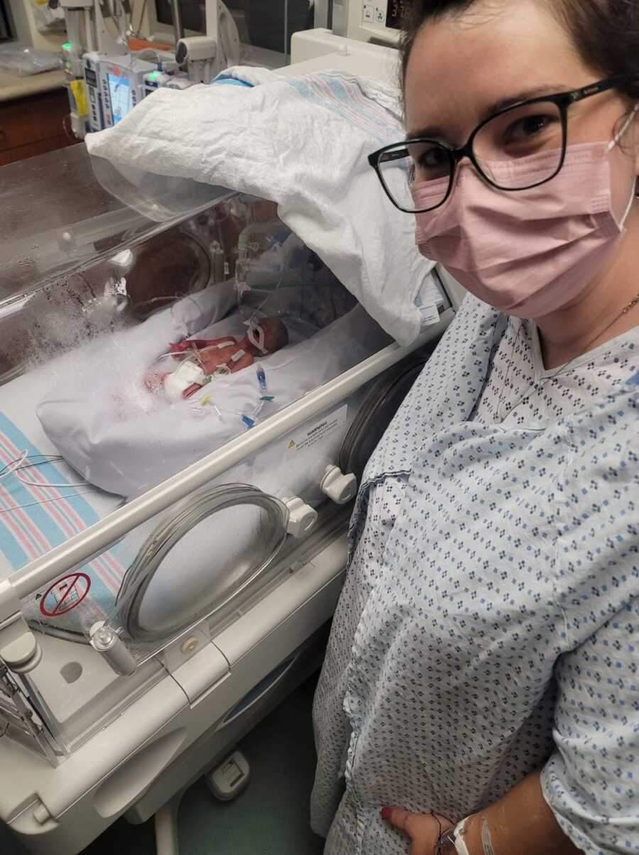nicu mom stands by her baby while she is attached to machines and breathing assistance