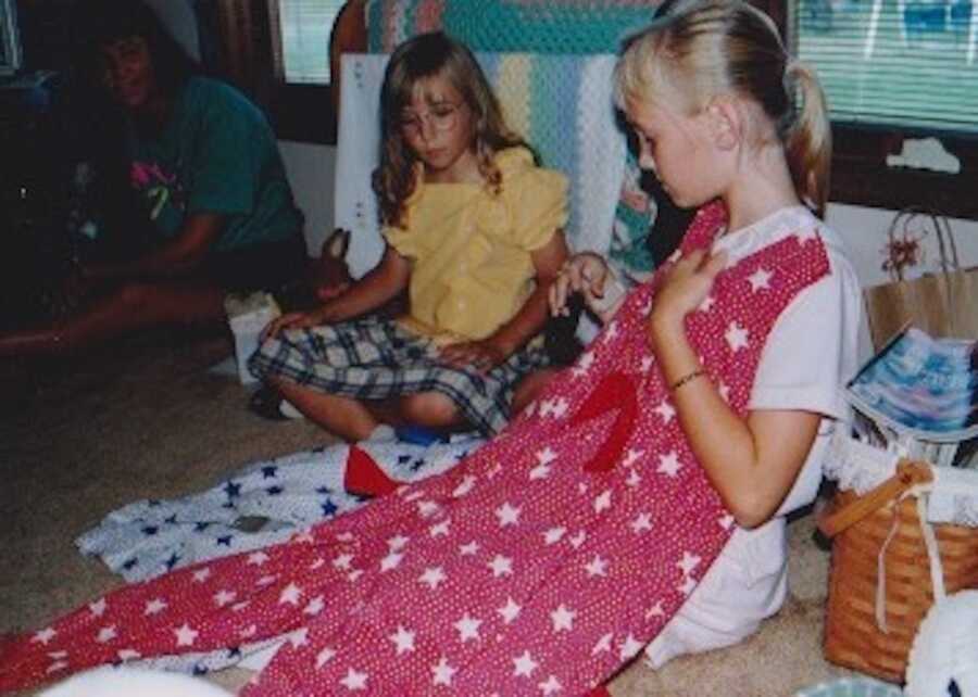 throwback photo with young girl holding upped Christmas sweater sewn by her grandmother