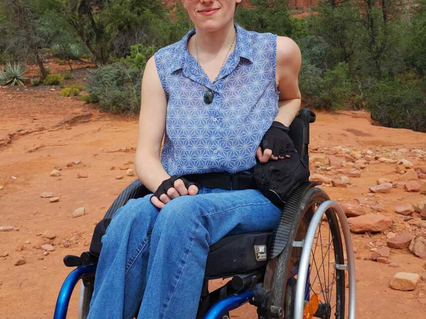 Paraplegic woman wearing suglasses sitting in wheelchair