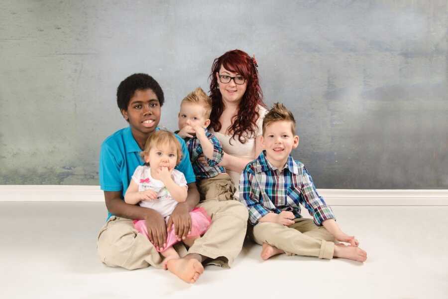 siblings through adoption sitting together for a photoshoot