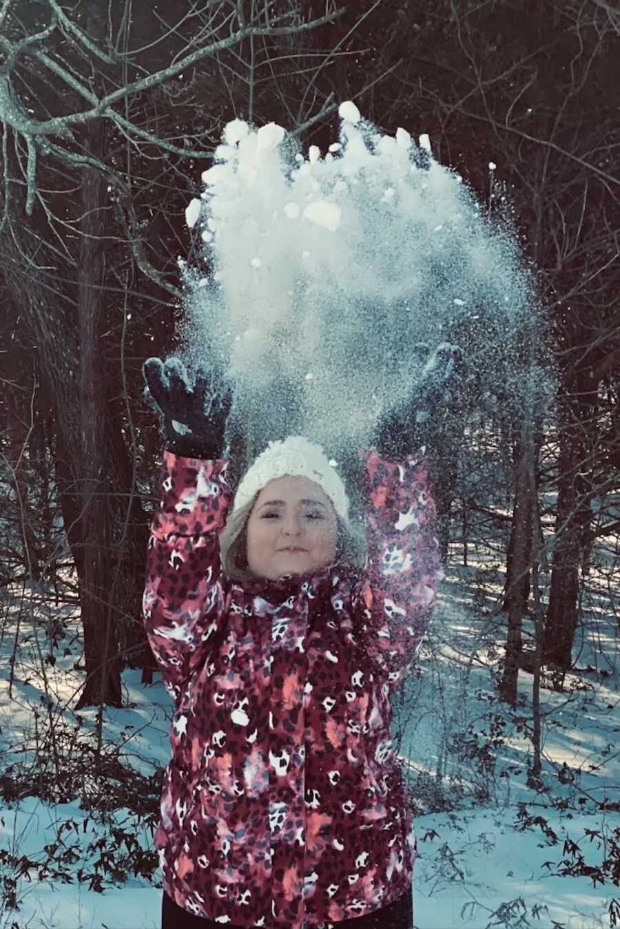 unmarried widow throws a handful of snow into the air